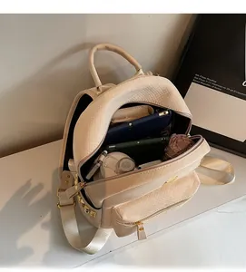 Detail of spacious cream backpack interior showing storage for tablet and daily items