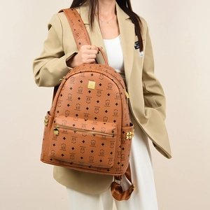 Detail of vintage brown monogram backpack with cartoon bear patterns and gold studs