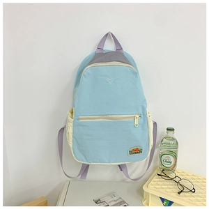Close-up of blue and purple kids backpack with TOCHASO brand embroidery and side pocket