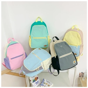 Detail view of colorful nylon kids backpacks with multi-pocket design and contrast colors
