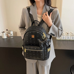 Classic black monogram backpack with gold studs and cute dog charm for women