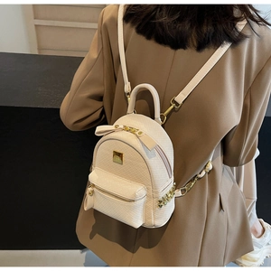 Chic beige woven texture mini backpack with golden zipper detail and stylish bow