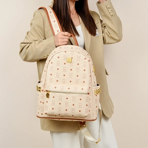 Fashionable oversized backpack with cute bear print and gold studs shown on a model