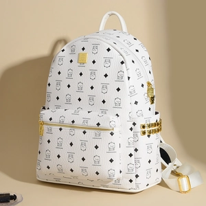 Close-up of white leather backpack with bear print and gold pyramid studs detail