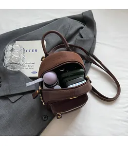 Detail of stone pattern mini backpack showing interior capacity with umbrella and daily essentials