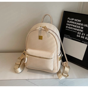 Detail of off-white woven leather backpack showing gold hardware and rivet side pockets