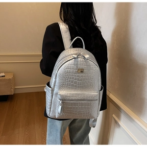 Premium silver crocodile embossed leather backpack for women shown on model's back
