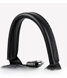 Close-up of the black leather backpack handle with meticulous stitching and metal D-ring