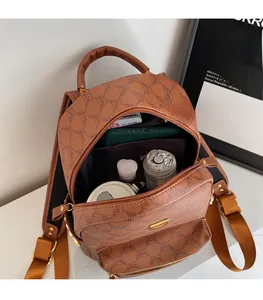 Detailed view of the open interior space and capacity of the brown printed PU backpack