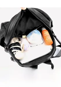 Internal view of the black quilted backpack showing spacious storage for daily items