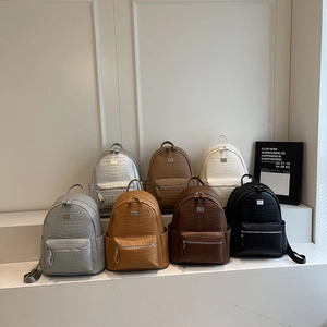 Detailed display of crocodile pattern leather backpacks in seven various stylish colors