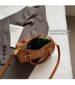 Brown barrel bag with cute bear print showing interior storage for phone and makeup