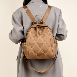 Brown quilted nylon backpack for women with luxury diamond pattern and metal logo