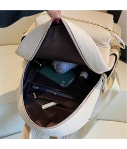 Macro shot of spacious inner compartments and stone texture on white commuter backpack