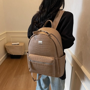 Brown crocodile texture faux leather backpack for women with multi-pocket design and metal logo