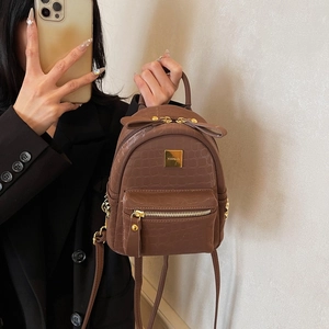 Brown faux crocodile leather mini backpack with gold logo plate and side rivets for women