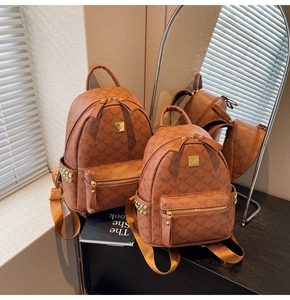 Detail of classic brown monogram backpack with gold-tone hardware and side stud accents