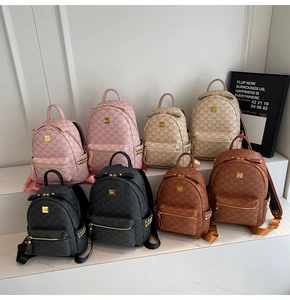 Multiple colors of college style backpacks with bear print and golden studs details