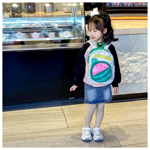 Detail showing high-quality canvas fabric on kid backpack with green dinosaur pattern