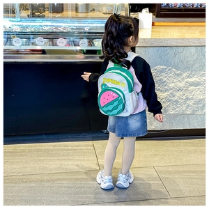 Detail of kids dinosaur backpack with side mesh pocket and cute watermelon pattern