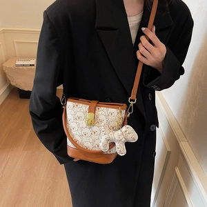 Chic women's bucket bag with cute bear print and plush puppy charm accessory