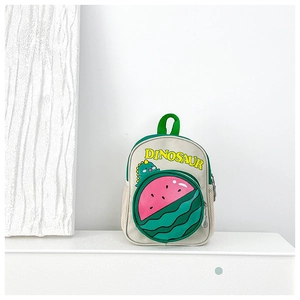 Detail view of canvas kids backpack with watermelon pocket and 3D dinosaur element
