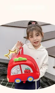 Detailed view of the cute red car-shaped children backpack with rabbit and strawberry prints