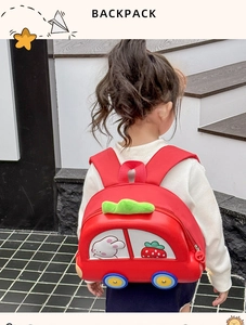 Toddler car-shaped backpack with cute strawberry and rabbit prints shown on a child model