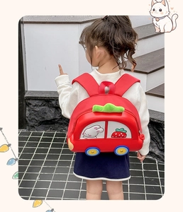 Toddler wearing a red car-shaped EVA hardshell backpack with cute rabbit illustrations