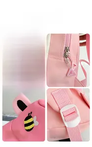 Detail view of pink backpack featuring wide handle, easy-grip zipper and bee embroidery