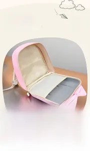 Pink shell backpack interior showing multi-layer storage with mesh pocket and bow detail