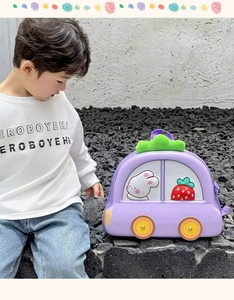 Detail view of purple car-shaped EVA hardshell kids backpack with cute rabbit and strawberry