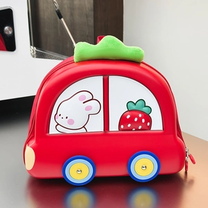 Close-up of a red EVA hard shell car-shaped toddler backpack with green plush handle