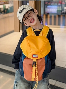 Detail of multi-color kids backpack featuring durable nylon and secure buckle closure