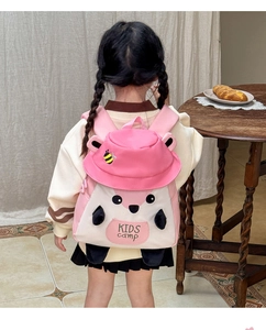 Detail view of the pink cartoon squirrel kids backpack featuring embroidery and canvas straps
