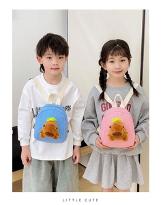 Detail of pink and blue mini children backpacks featuring 3D plush capybara mascots