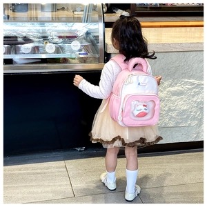 Toddler backpack detail showing a plush kitty doll inside a transparent front pocket