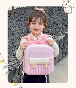 Close-up of pink hardshell kids backpack with large 3D bow and padded shoulder straps