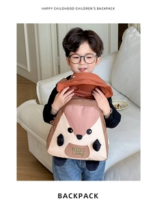 Detail of cute squirrel themed kids backpack and sun hat worn by a boy in home setting