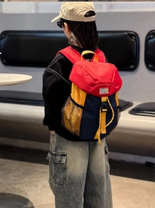 Macro view of kids contrast color backpack with durable nylon fabric and secure buckle closure