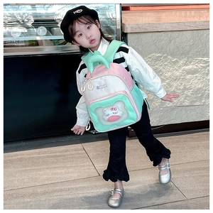 Pink and mint green backpack with a transparent window featuring a cute cartoon plush doll
