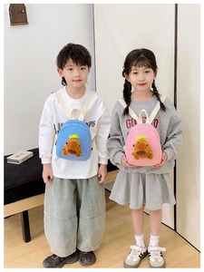 Kids mini backpacks in blue and pink featuring cute plush capybara on the front
