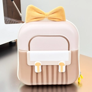Detail of cute hardshell toddler backpack featuring a large yellow bow and pink stripes