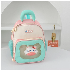Detail of color-block backpack with transparent heart window and plush cat insert