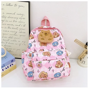 Détail du sac à dos enfant à motif Capybara, carreaux roses et pendentif pelucheux 3D
