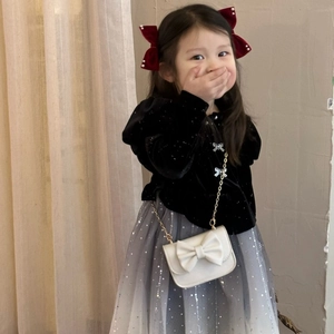Detail of a velvet girls bag with pearls and a red bow on a princess outfit