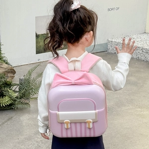 Pink eggshell backpack for kids with a large sweet bow design and ergonomic straps