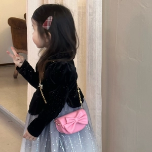 Girl's pink mini crossbody bag with a bow detail styled with a tutu skirt and velvet top