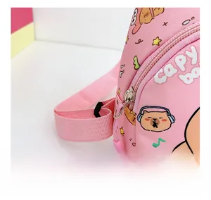Detail of pink cartoon Capybara bag featuring smooth silver zipper and durable strap