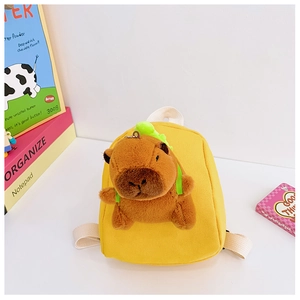 Close-up of yellow canvas toddler backpack with a cute plush Capybara toy and woven straps